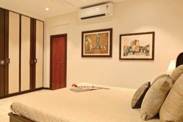 "A clutter-free bedroom with minimalist style and ergonomic furniture."