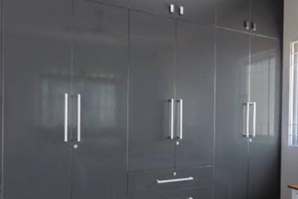 "Custom corner wardrobe ideal for small spaces with mixed storage options"